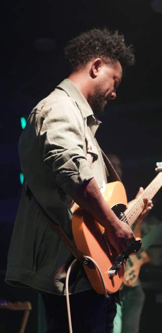 Zeruabbel Molla playing an electric guitar on stage.